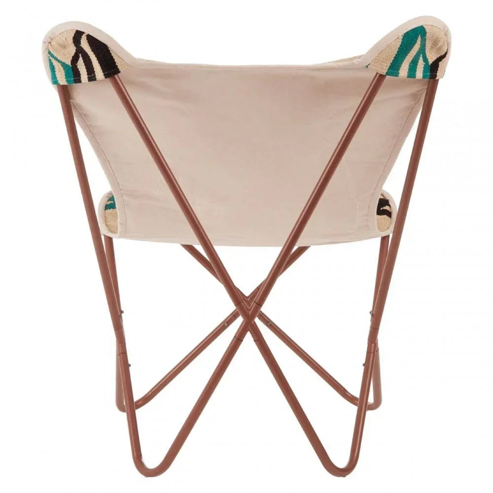 Beige butterfly chair with brown metal frame and patterned fabric details on corners, rear view