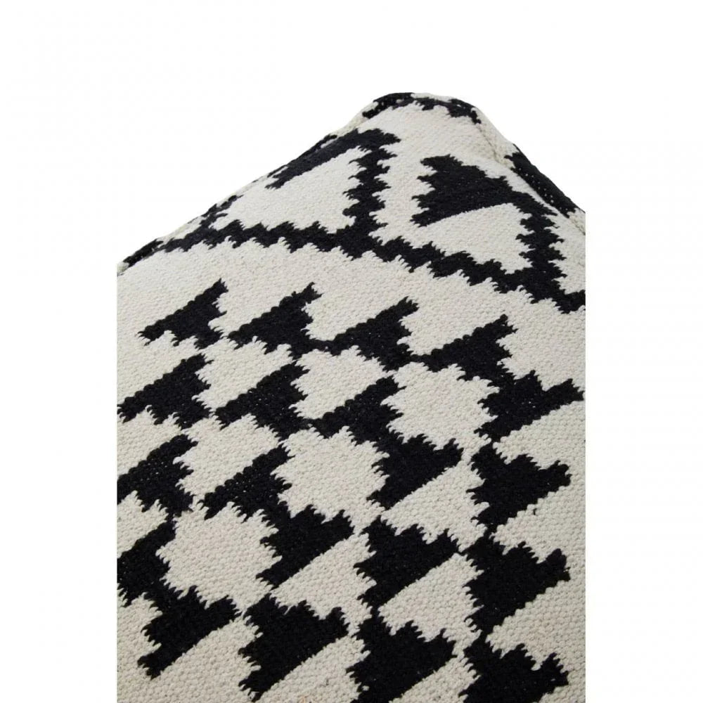 Black and white cotton cushion with geometric zigzag pattern, close-up texture view