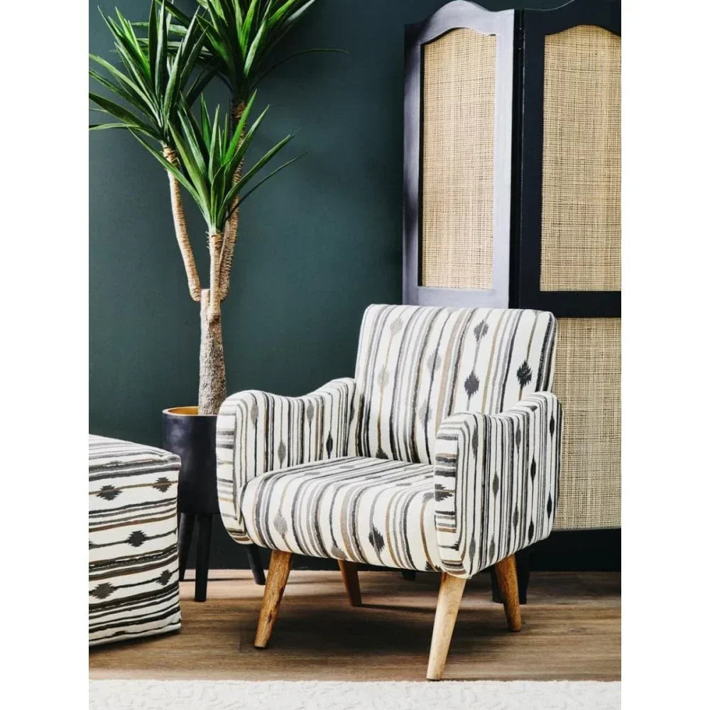 Striped accent armchair with wooden legs in modern living room setting next to indoor plant
