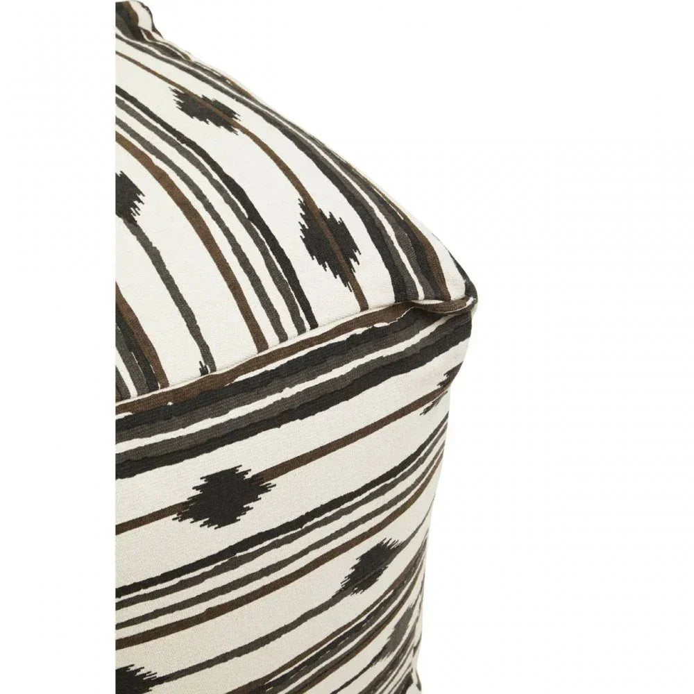 Close-up of patterned cushion with brown and black stripes and diamond motifs