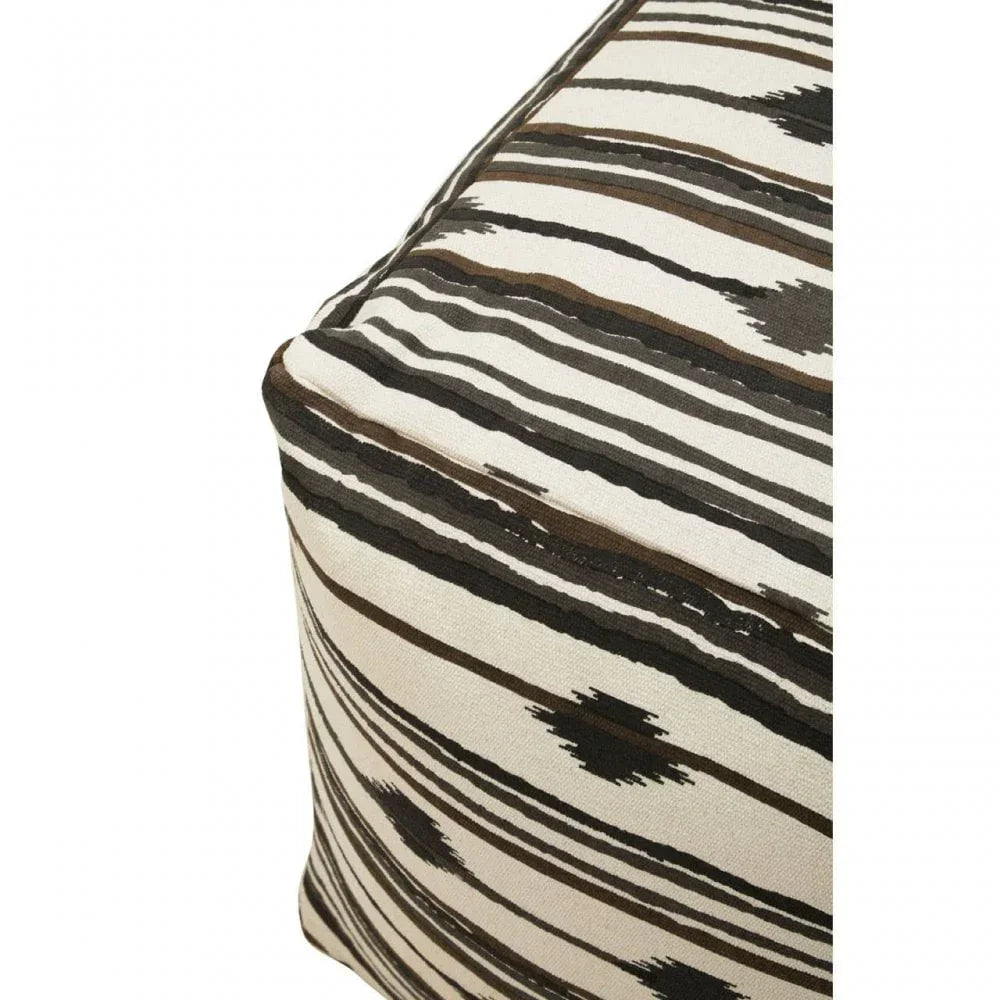Close-up of fabric pouffe corner with black and brown geometric stripe pattern
