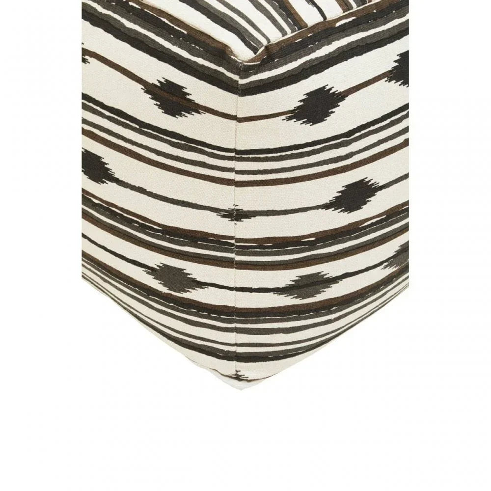 Corner detail of fabric ottoman with black and brown geometric stripe pattern