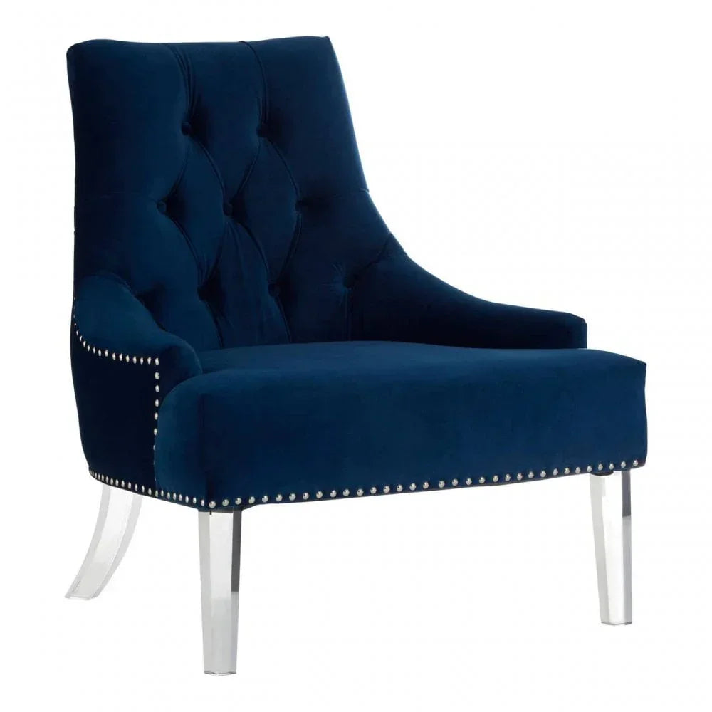 Navy blue velvet accent chair with button-tufted back, studded trim and clear acrylic legs