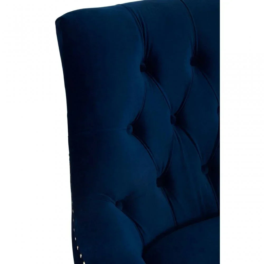 Close-up of navy blue velvet tufted chair backrest with button detail