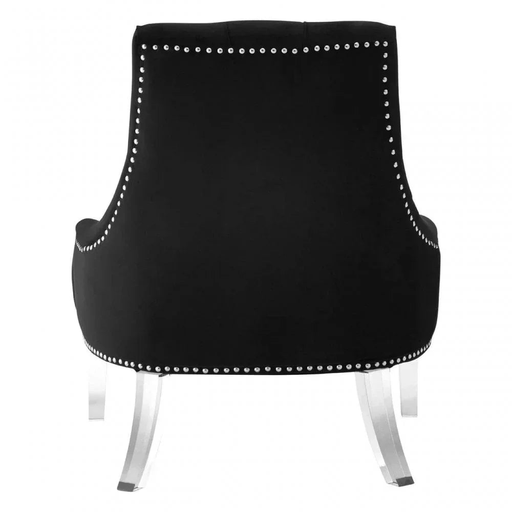 Black velvet accent chair with silver stud trim and clear acrylic legs, rear view
