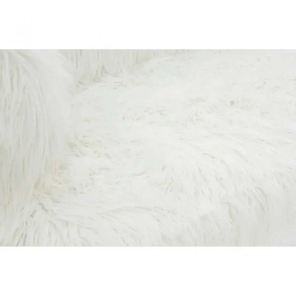 Closeup of white faux fur sofa upholstery and cushion texture