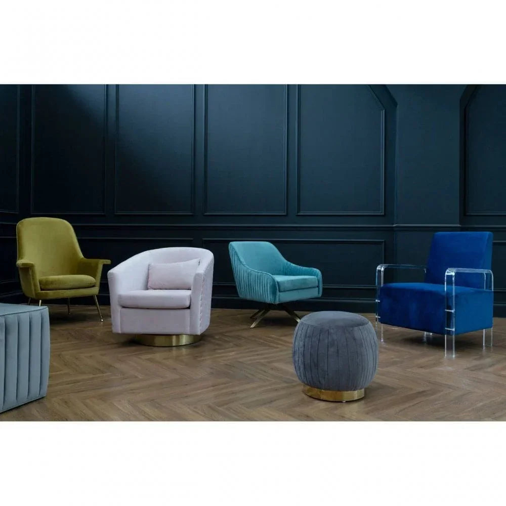 Modern velvet accent chairs in green, pink, teal, and blue with matching pouffe on wood floor