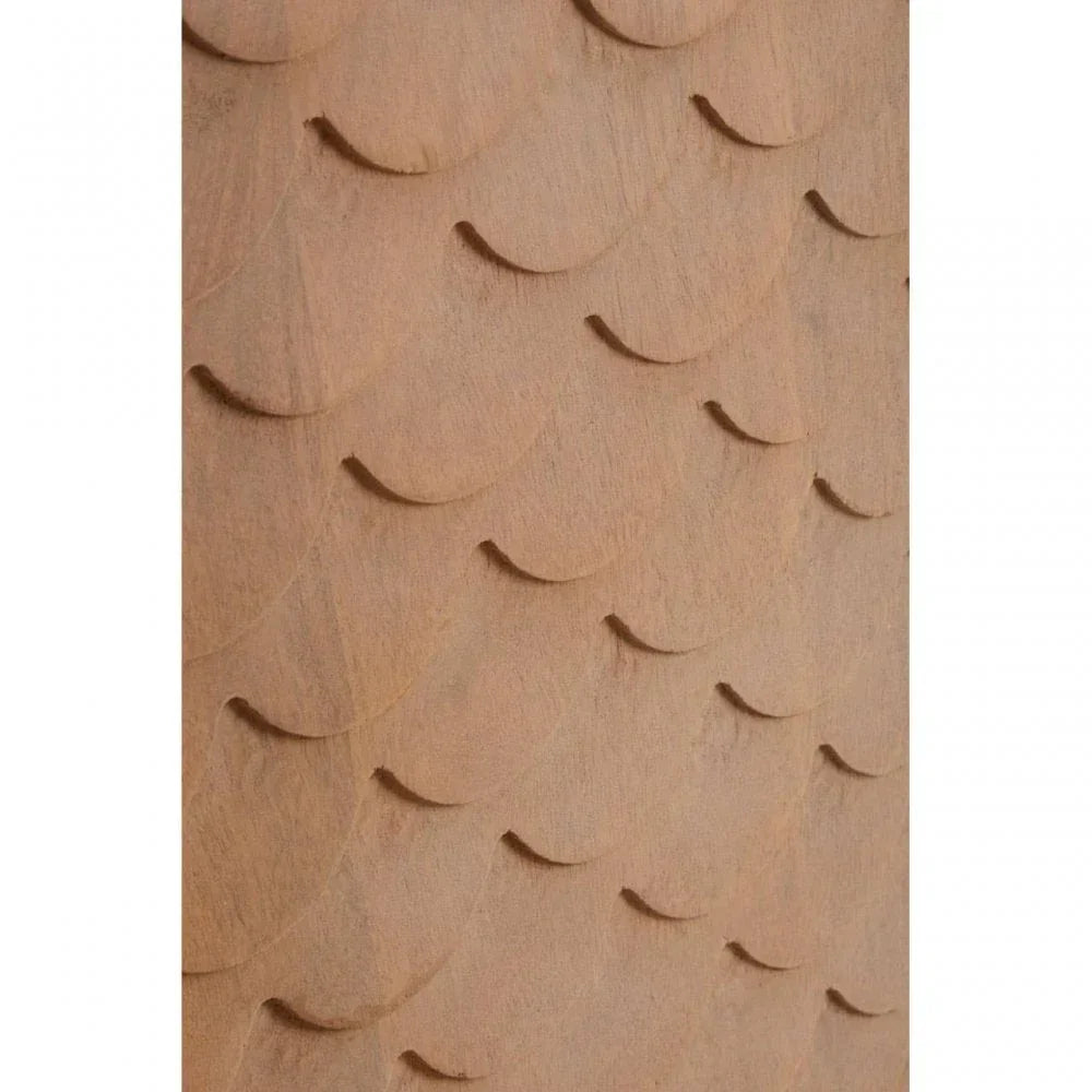 Textured wooden furniture panel with carved scallop pattern close-up