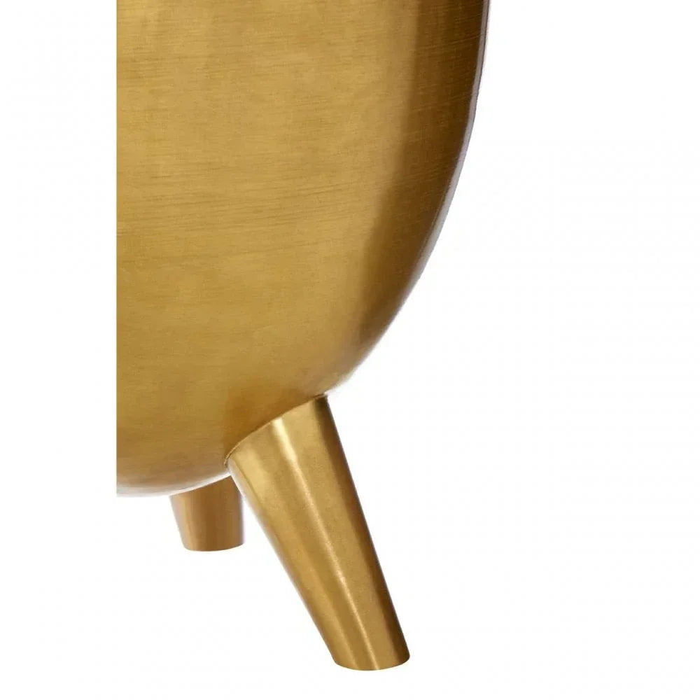 Close up of gold metal planter leg and textured curved pot body