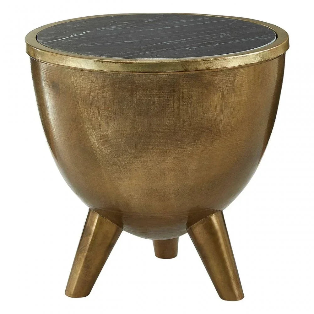 Round gold metal side table with black marble top and three legs