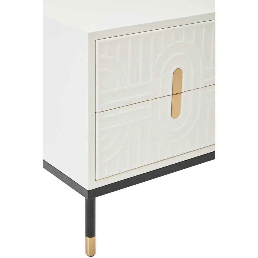 White bedside table with gold accent handles and geometric drawer fronts on black legs