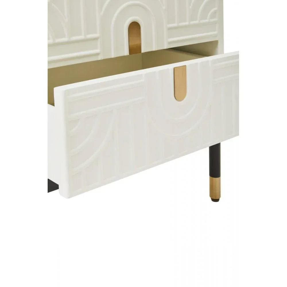 White bedside table with carved geometric drawer front and gold accent legs