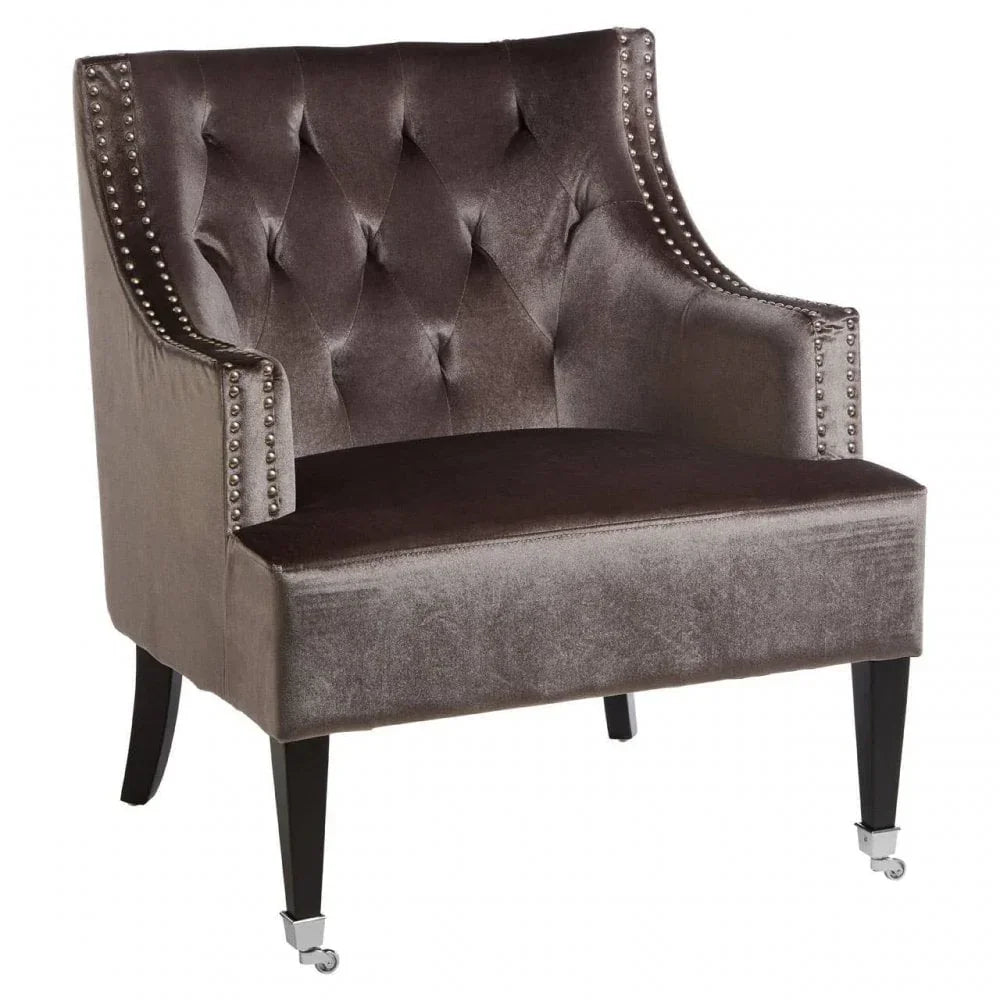 Velvet accent chair with button-tufted back, silver stud trim and dark wooden legs