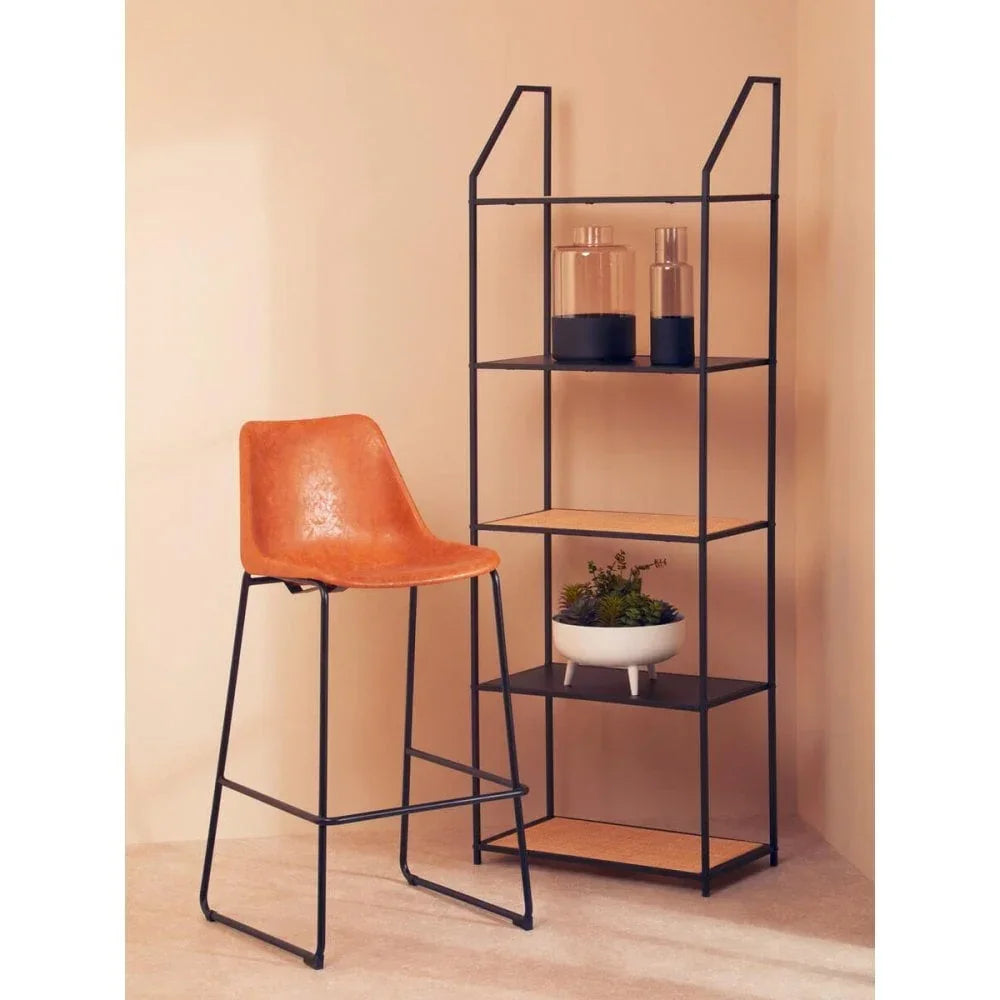 Brown faux leather bar stool with metal frame beside black metal shelving unit with décor