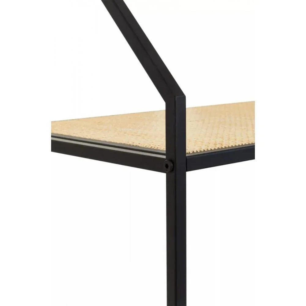 Closeup of furniture with black metal frame and woven cane shelf