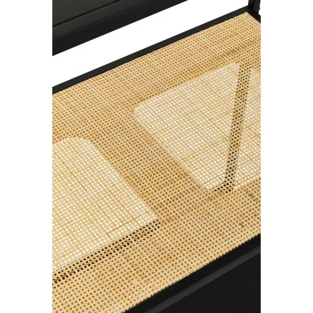 Closeup of rattan shelf with black metal frame, showing woven cane detail and glass surface