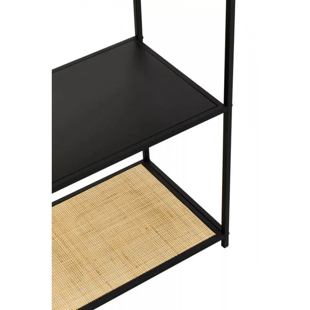 Black metal shelving unit with solid top shelf and lower rattan shelf, close-up view