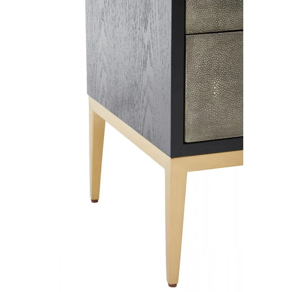Close view of bedside cabinet with textured drawers, gold legs and wood side panel