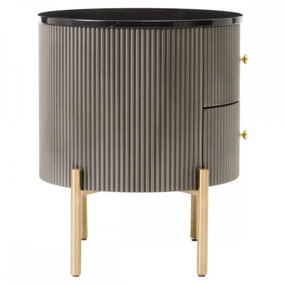 Round bedside table with ribbed grey finish, black top, two drawers, gold legs and handles
