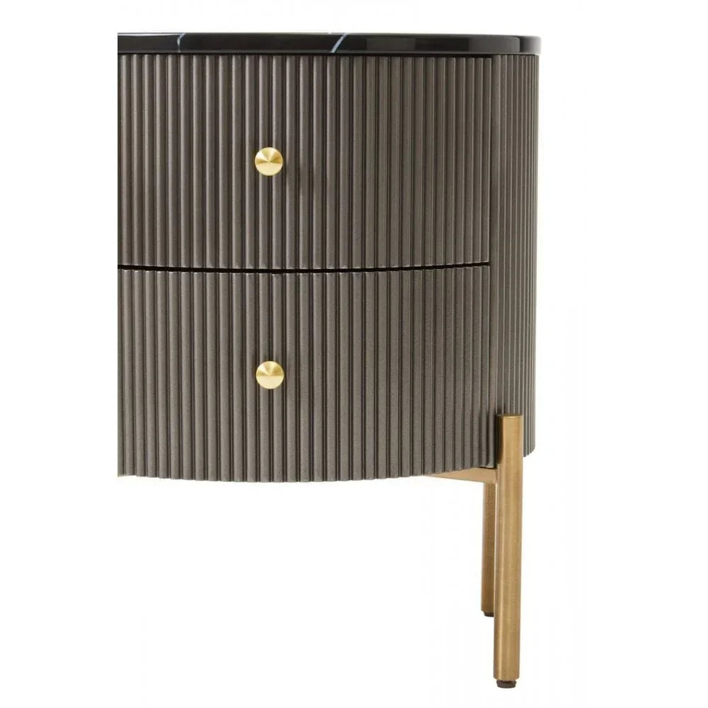 Modern bedside table with black ribbed drawers, gold handles, and gold metal legs