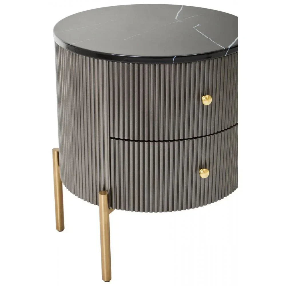 Round bedside table with fluted grey body, black marble top and gold metal legs