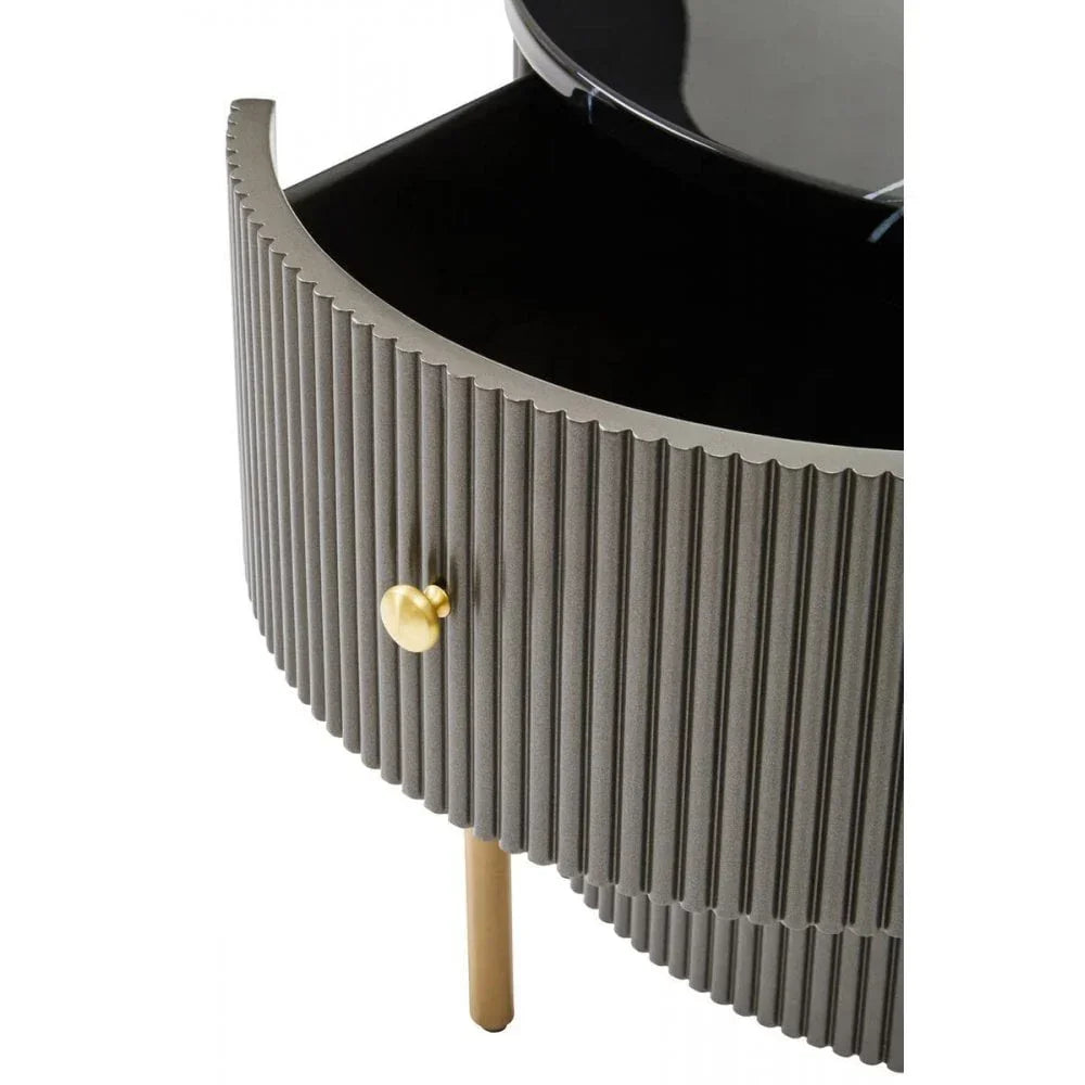 Grey ribbed bedside table with gold knob and open drawer, close-up view
