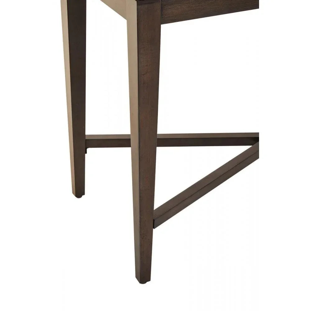 Dark wooden table legs with cross brace detail, angled view of dining table base
