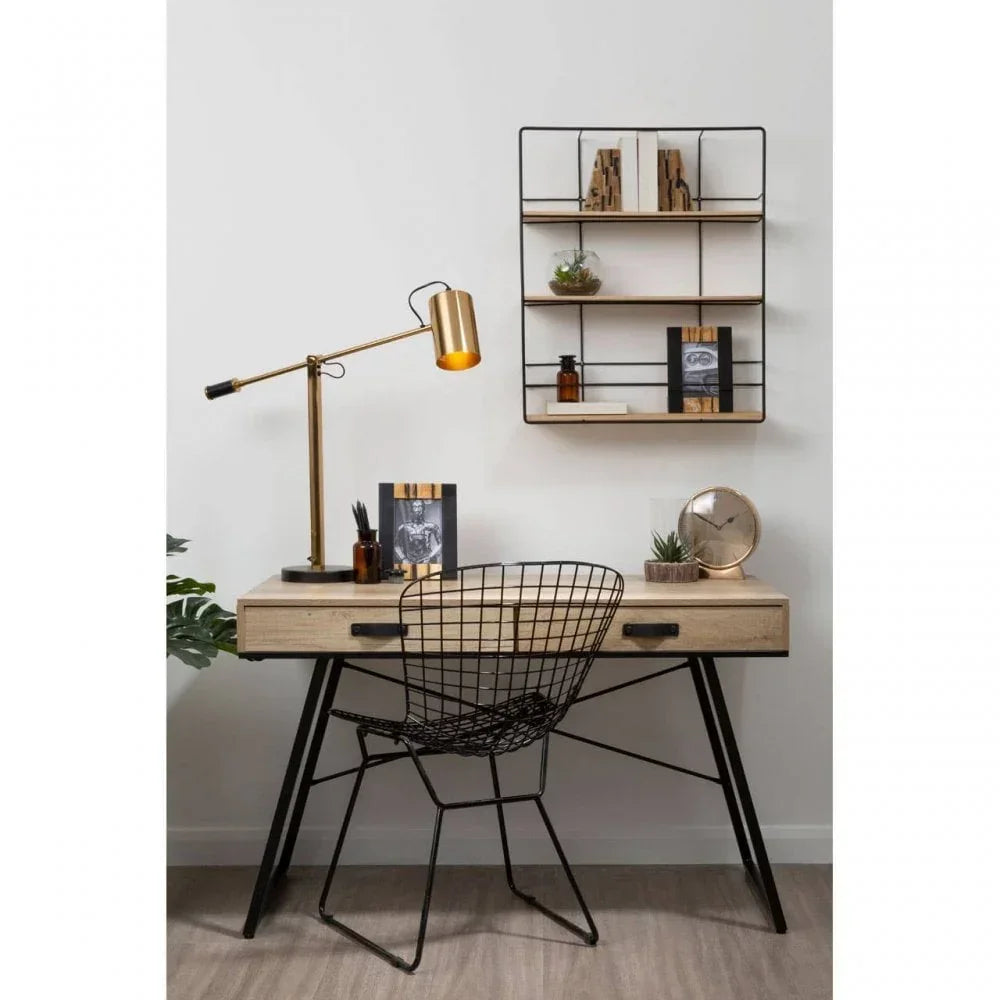 Wooden desk with black metal legs, mesh chair, and gold desk lamp in modern home office