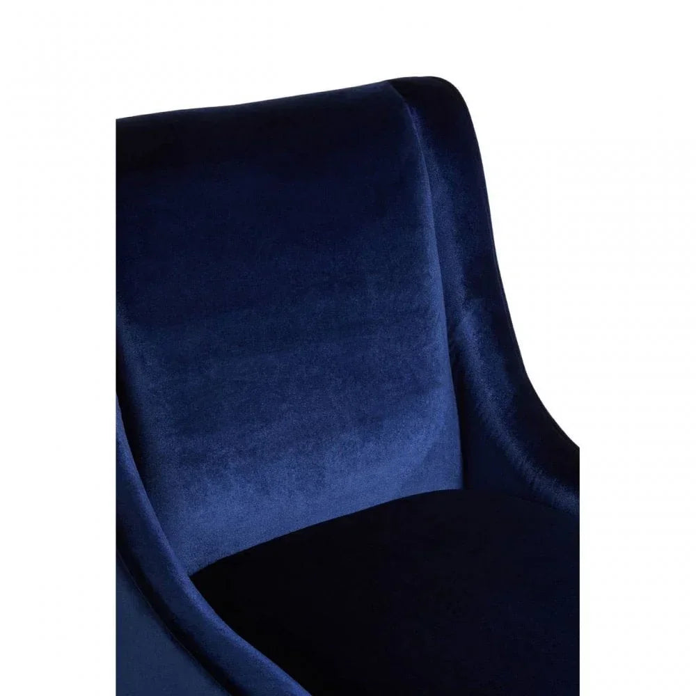Closeup of navy blue velvet accent chair with curved backrest