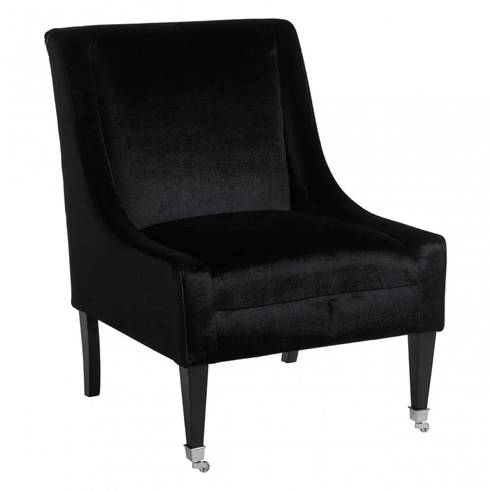 Black velvet accent chair with low back, dark wood legs and front castor wheels