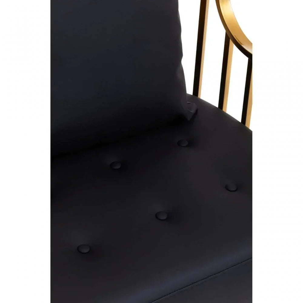 Black upholstered chair seat with button detailing and gold metal armrest