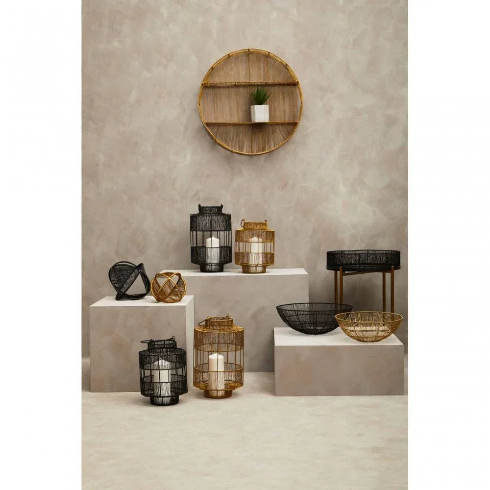 Wire candle lanterns and bowls in gold and black on display pedestals with wall shelf decor