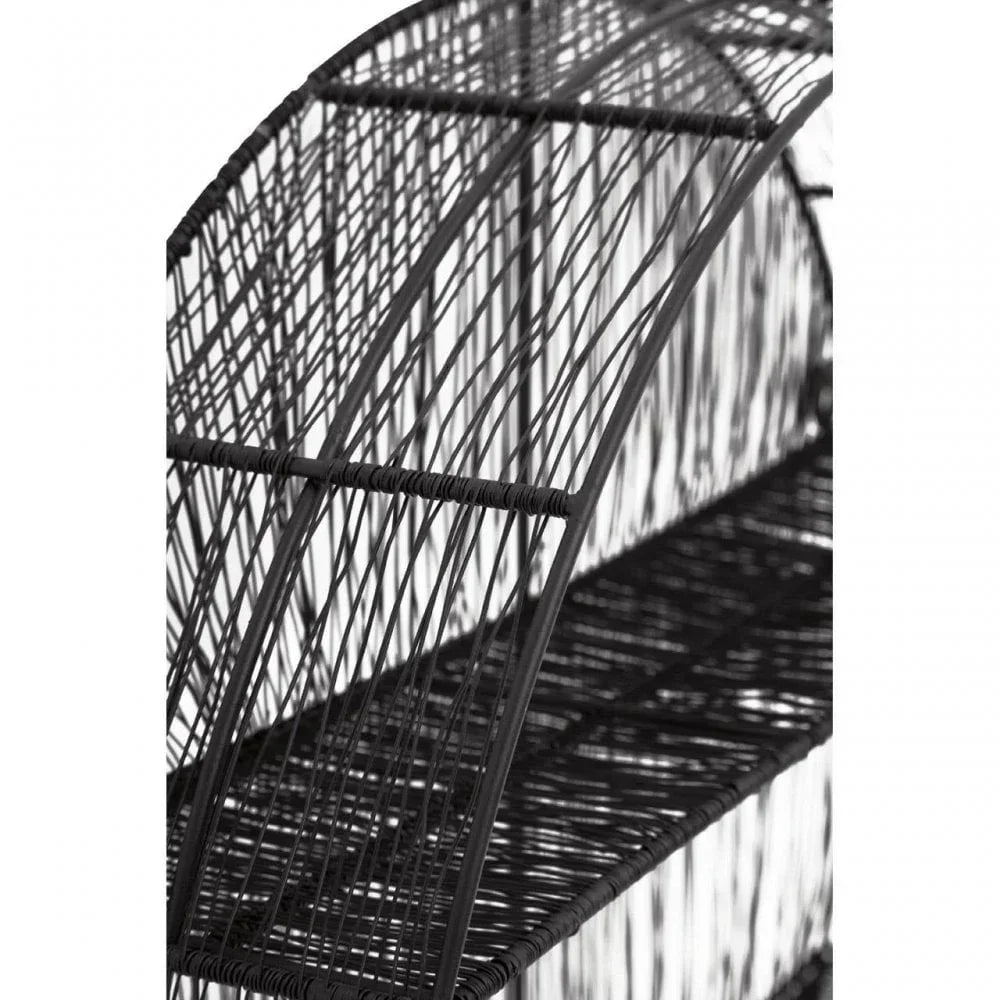Closeup of black rattan furniture shelf with woven design and curved frame