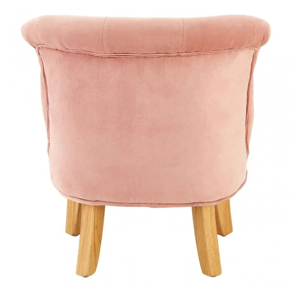 Rear view of pink velvet accent chair with light wooden legs