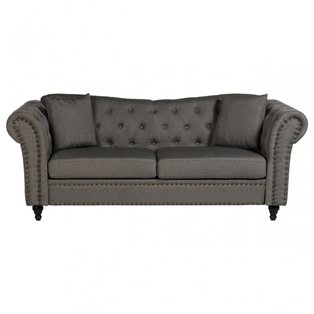 Grey fabric chesterfield sofa with button-tufted back, rolled arms, and studded trim