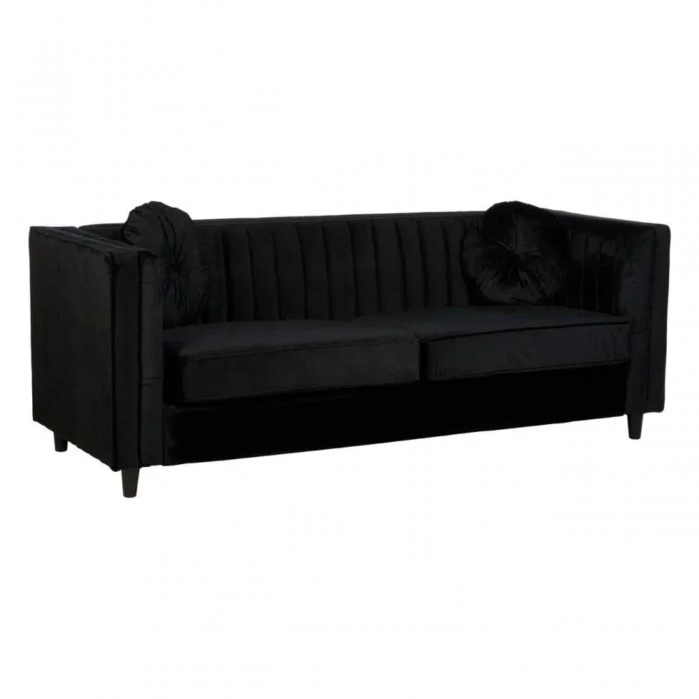 Black velvet sofa with vertical stitched backrest and round accent cushions