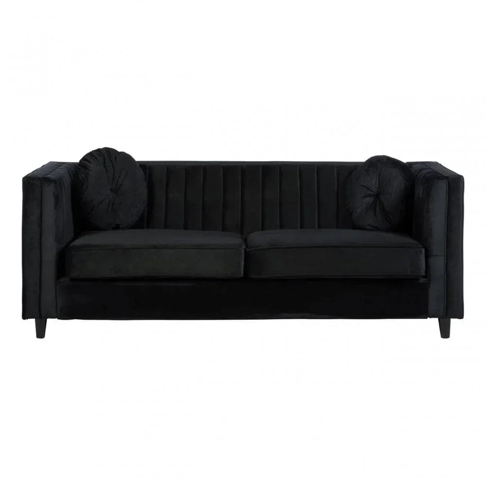 Black velvet sofa with tufted back and two matching round cushions, front view