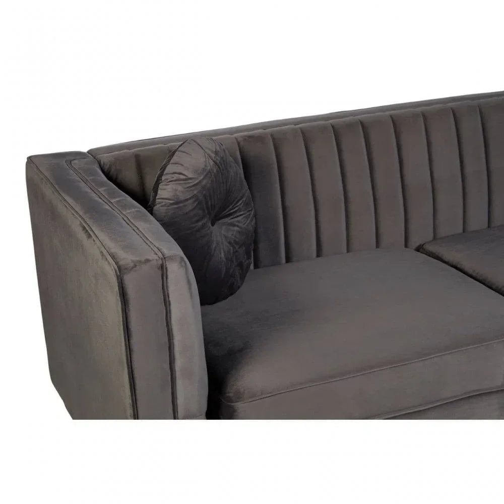 Grey velvet sofa with vertical stitched backrest and round cushion, corner angle view