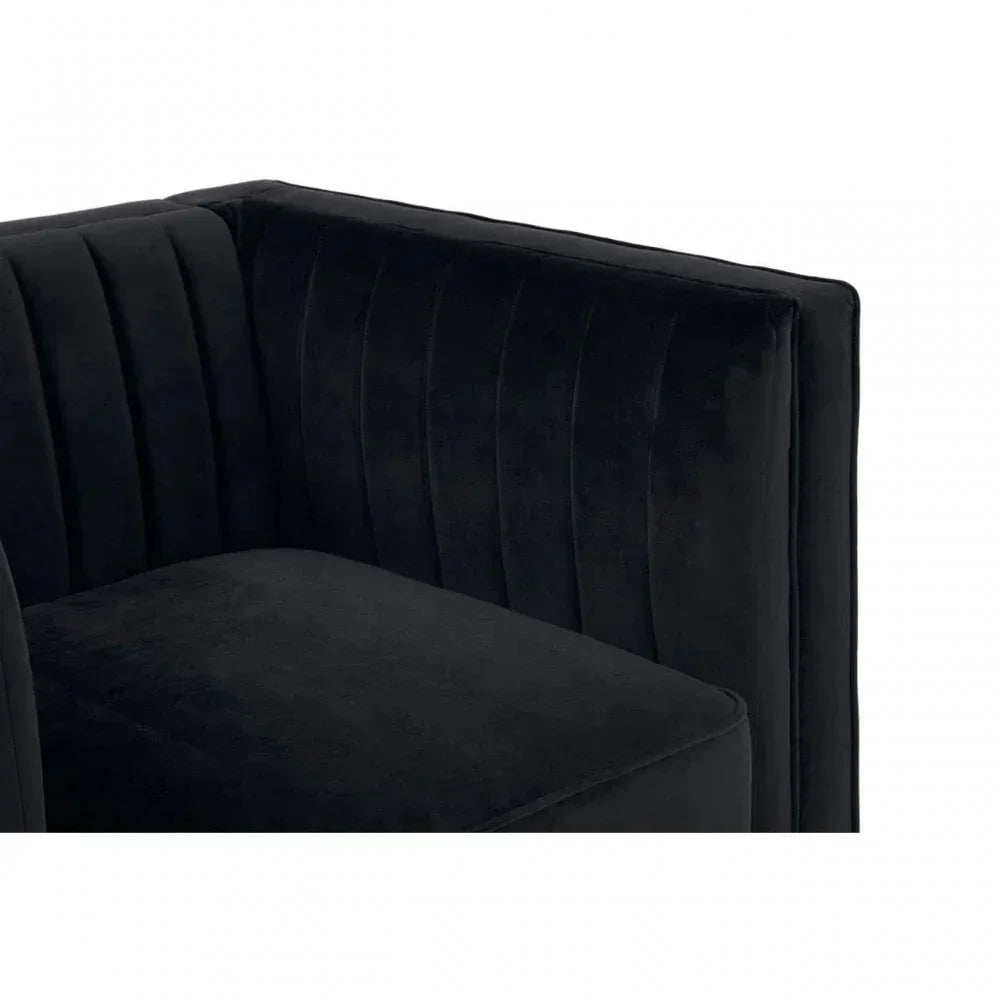 Black velvet armchair with vertical stitched backrest, close-up of corner view