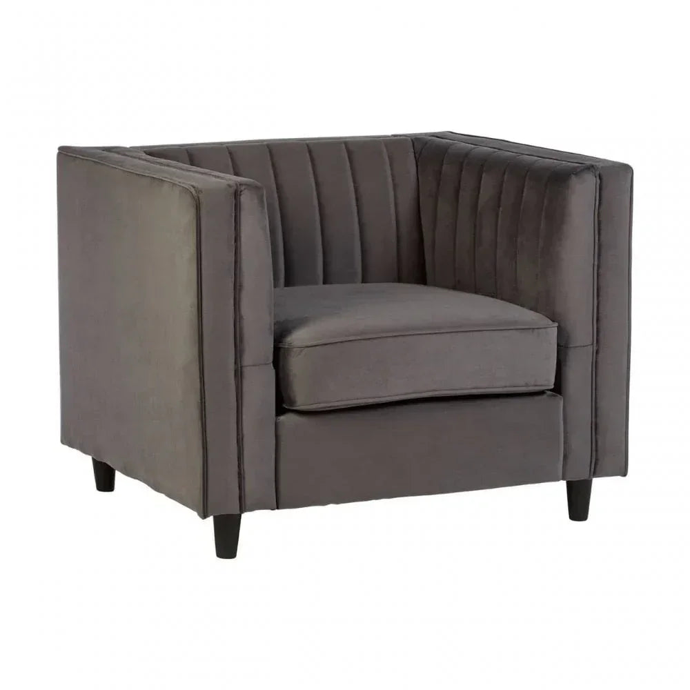 Grey velvet armchair with vertical stitched backrest and square arms on black legs