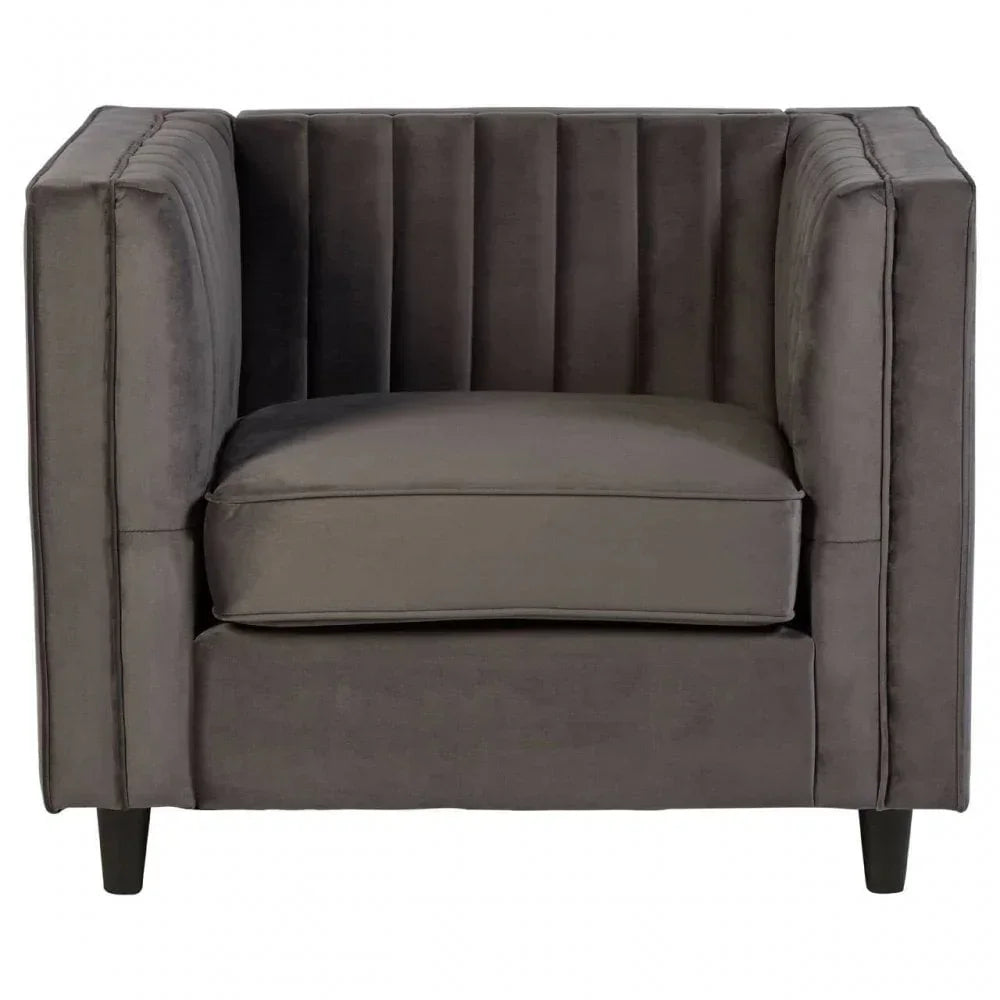 Grey velvet armchair with vertical channeled backrest and black legs, front view