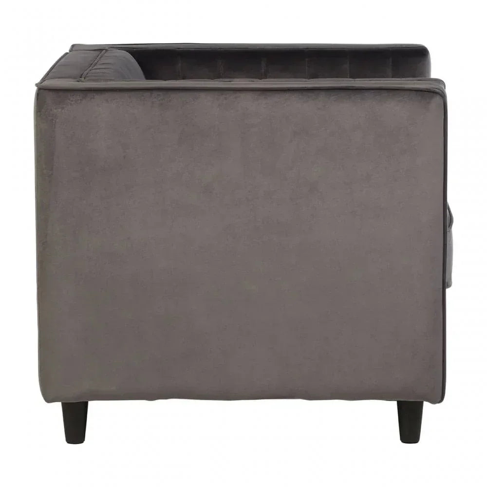 Side view of grey velvet sofa with dark wooden legs