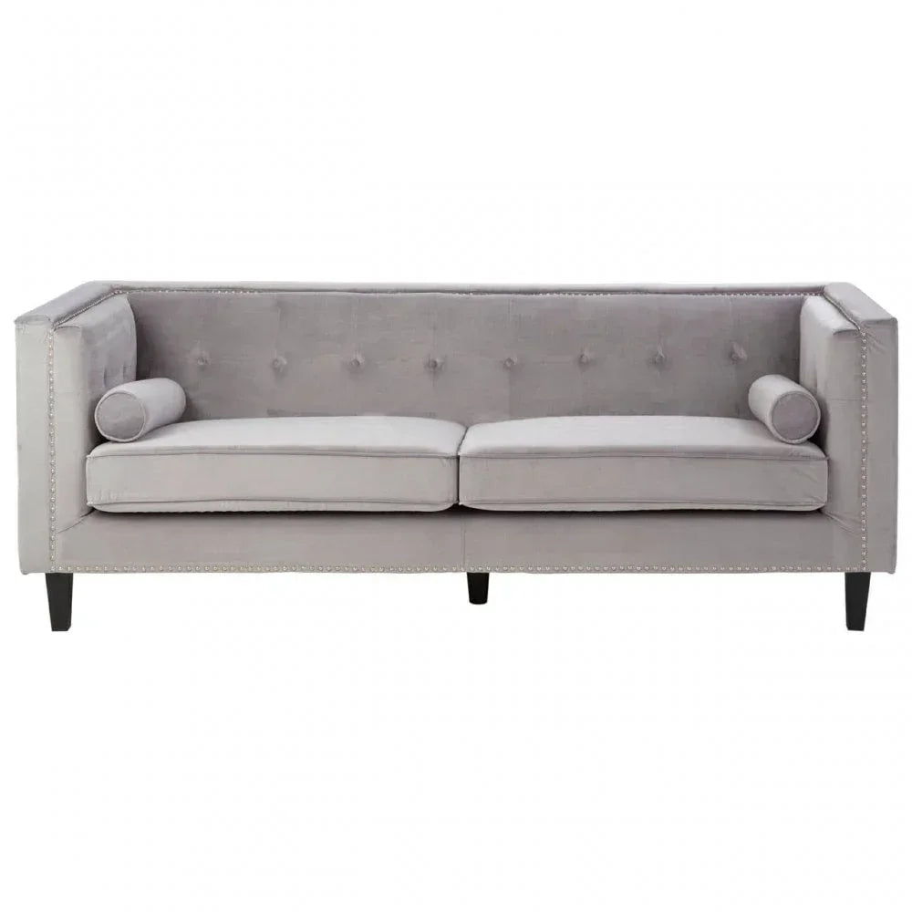 Grey velvet sofa with tufted back and silver stud trim, two seat cushions and bolster pillows