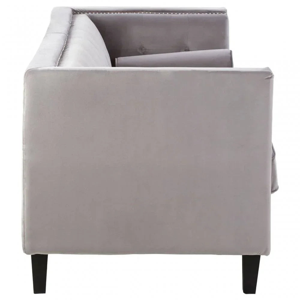 Side view of grey velvet sofa with black legs and nailhead trim