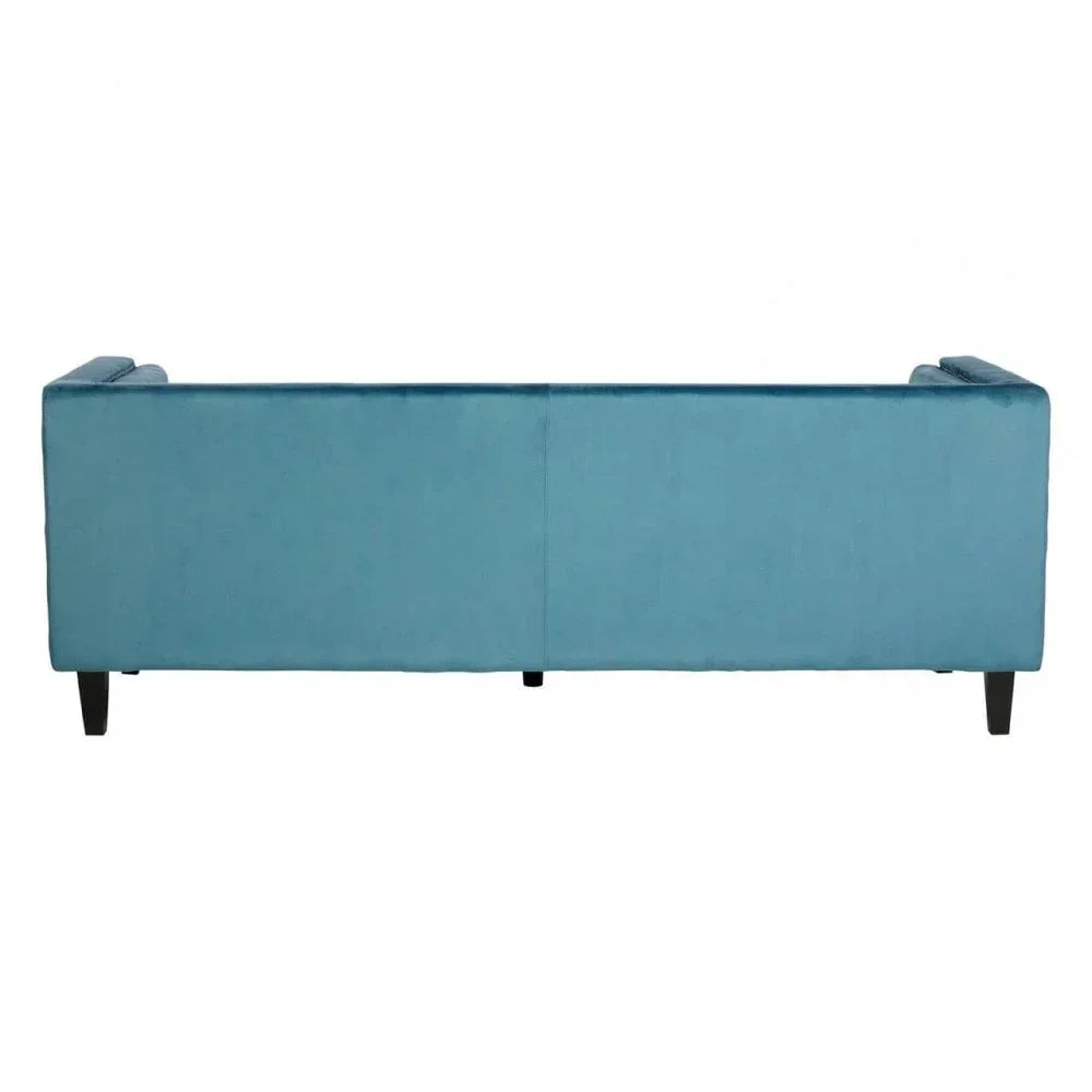 Rear view of a blue velvet sofa with black wood legs on white background