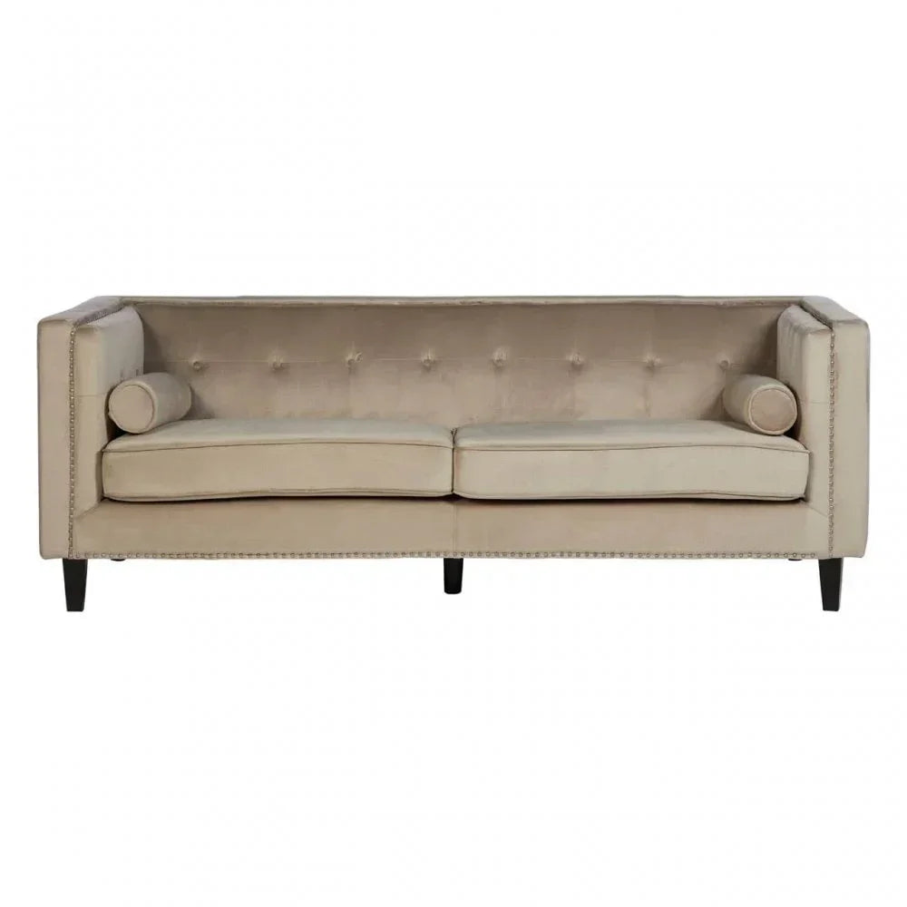 Beige velvet sofa with button-tufted back, two seat cushions, and cylindrical bolster pillows