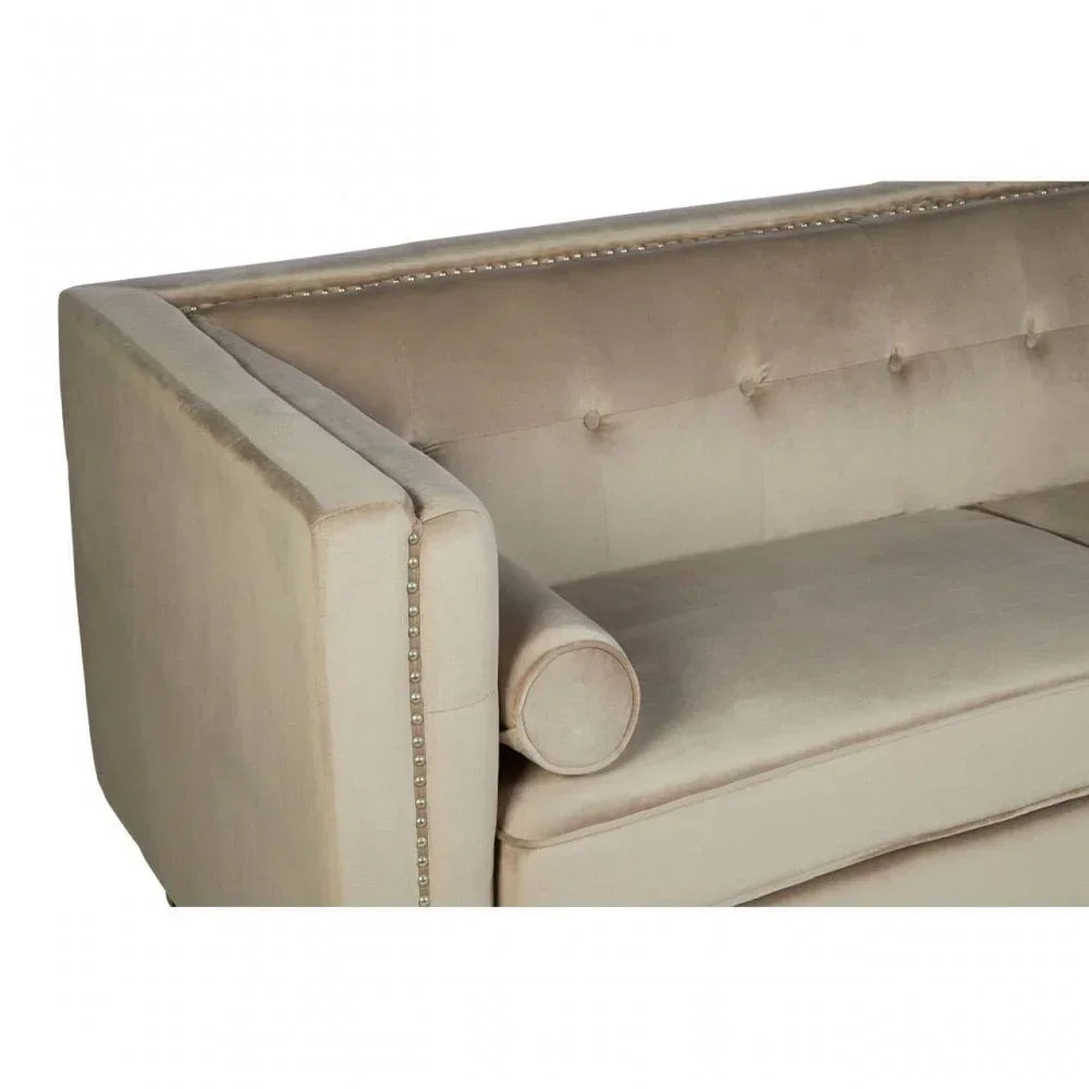 Beige velvet sofa with button backrest, silver stud trim, and matching bolster cushion