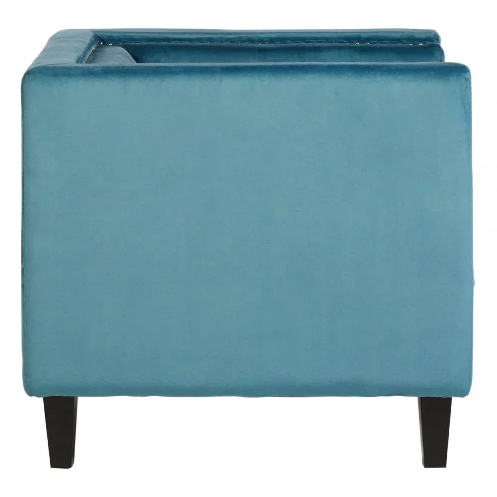Side view of blue velvet sofa with black wooden legs