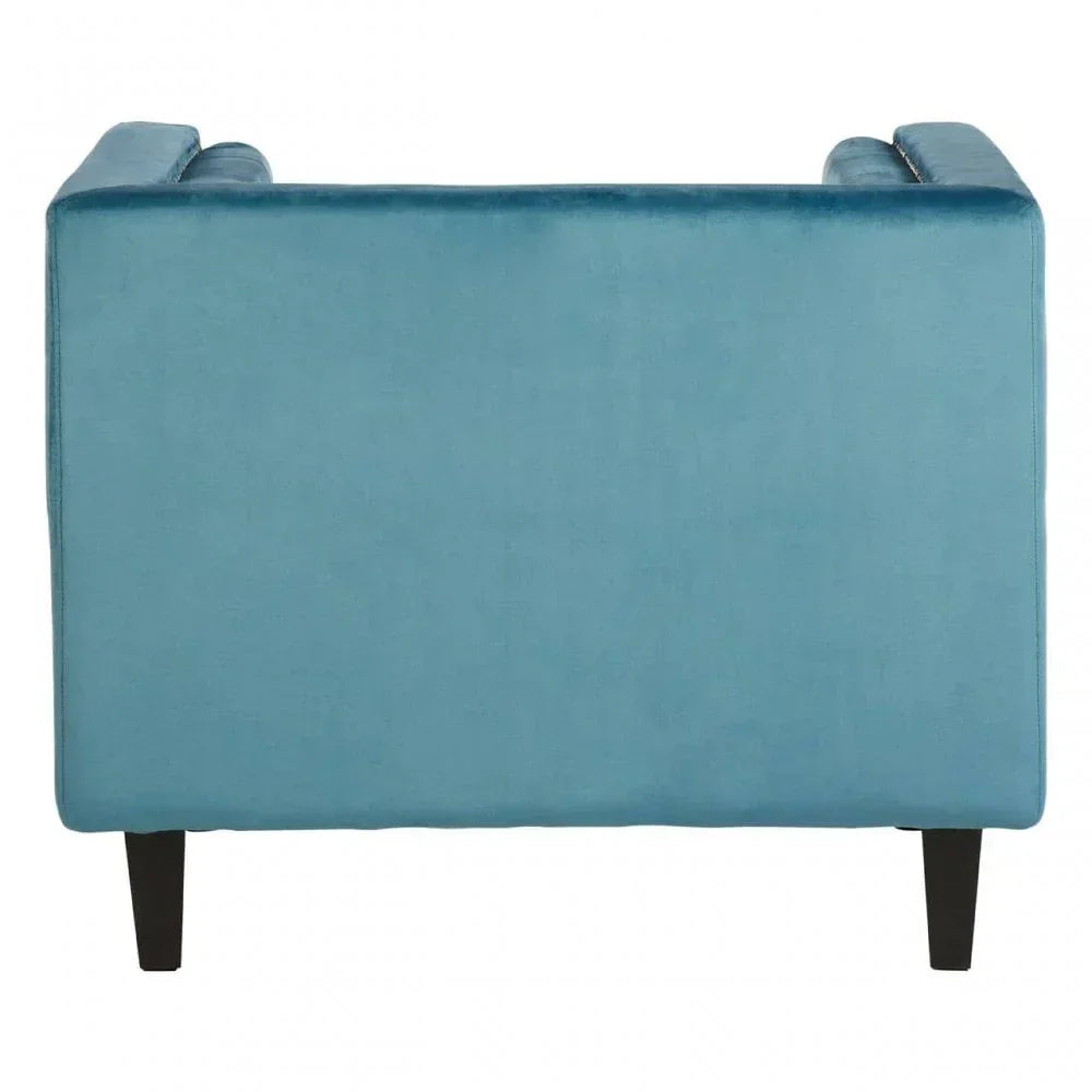 Back view of blue velvet sofa with slim black legs