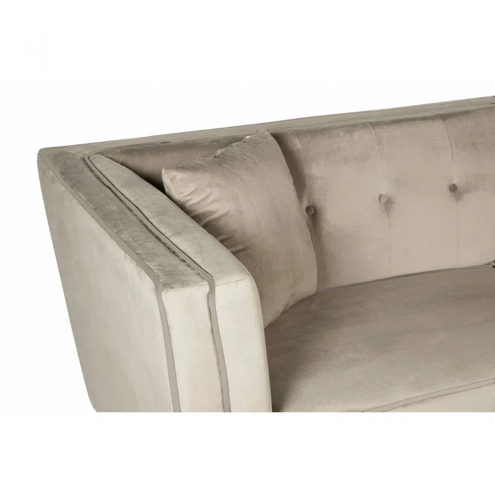 Beige velvet sofa corner with matching cushion and button-tufted backrest detail